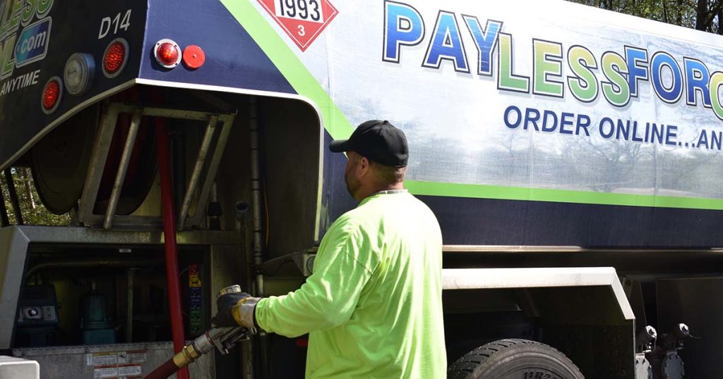 PayLessForOil.com delivery driver making a delivery