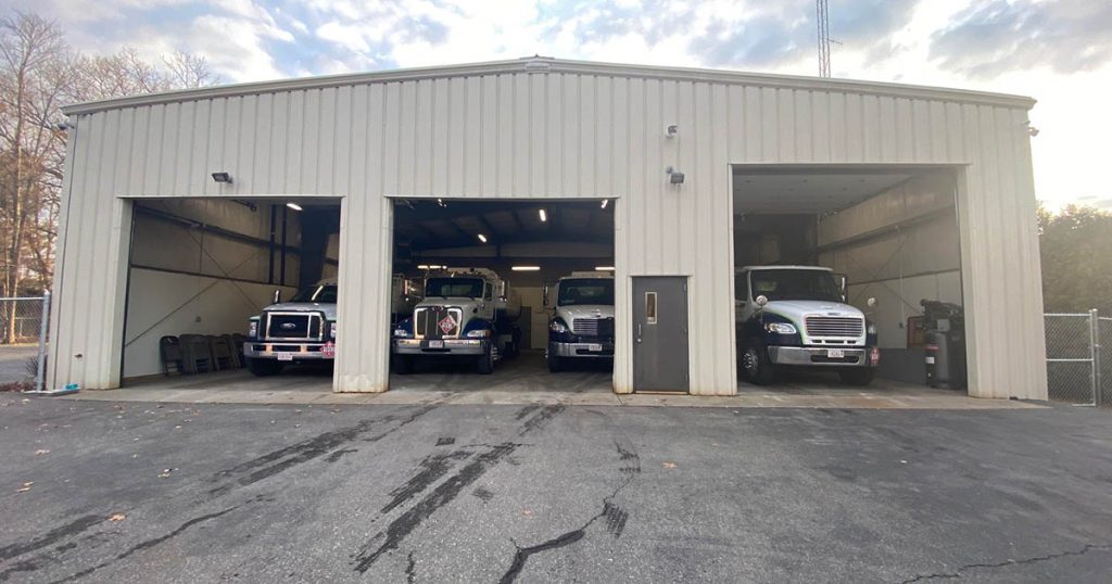 PayLessForOil.com trucks parked in garage